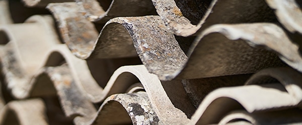 Asbestos sheets stacked on top of one another