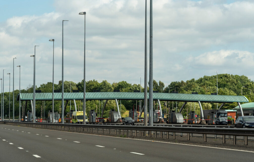 Wide view of M6 Toll plaza with cars approaching