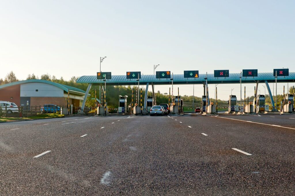 Side angle of M6 Toll plaza taken from moving traffic on adjacent lanes