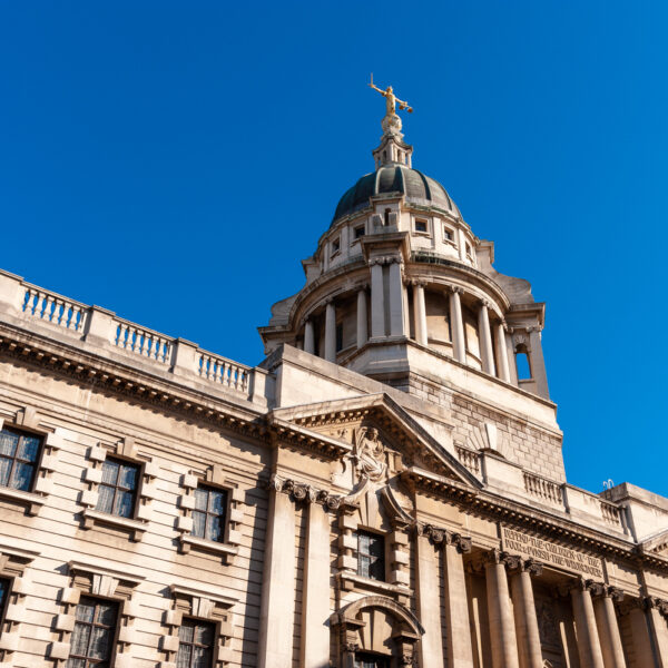 Exterior of the Old Bailey court building under a clear blue sky