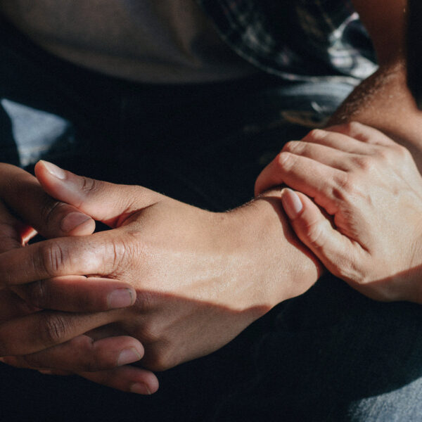 Close-up of hands showing comfort and reassurance.