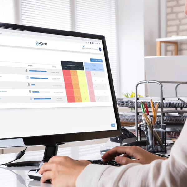 Person using the xCenta Essentials live risk monitor dashboard on a desktop computer
