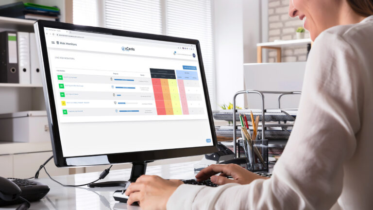 Person using the xCenta Essentials live risk monitor dashboard on a desktop computer